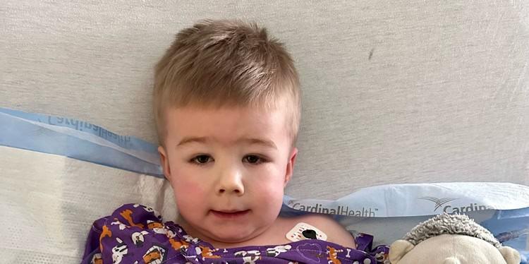 young boy named Crue with a fractured arm in hospital bed