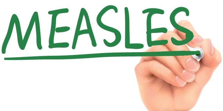 hand writing measles on a translucent board, measles infections, measles shots, measles vaccine, measles mumps and rubella, mmr, symptoms of measles, measles immunity, vaccinate children against measles