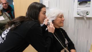 healthcare worker conducts ear exam