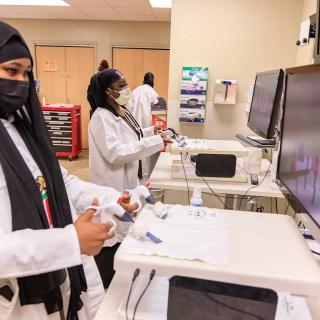 Black Youth with Stethoscopes using lab computers