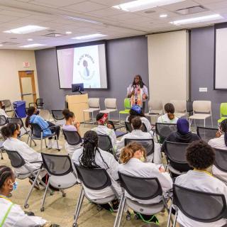Black Youth with Stethoscopes at a conference lecture
