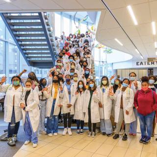 Black Youth with Stethoscopes group photo standing by steps