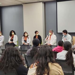 Panel of medical staff speaking to students during an orientation session.