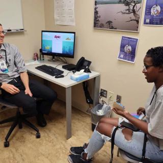 addiction medicine provider with patient in clinic room