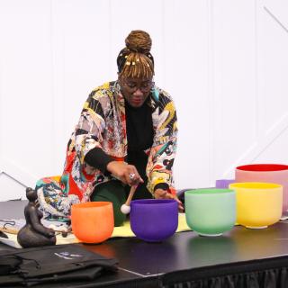 health equity attendee showing multicolored glass pots on a table, health equity summit