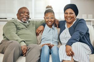 Two Grandparents Bonding With Their Grandchild On A Sofa At Home, senior care, hennepin county senior services, what is senior care, senior care phone number