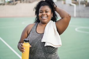 Woman Exercising and holding Water Bottle