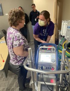 ECMO Program Coordinator Beth Heather, RN shows Jodie an ECMO machine and answers her questions, ECMO, burn, Stevens Johnson Syndrome, TENS, SJS, allergic reaction, Allergic reaction, lifesaving ECMO intervention, Stevens Johnson Syndrome, ECMO machine, mastectomy